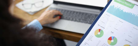 Woman in the office holding a statistical reportの写真素材