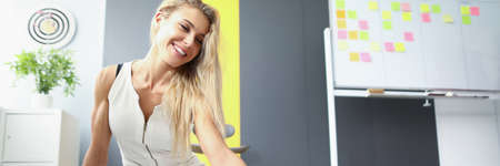 Beautiful woman sitting on the floor in the office