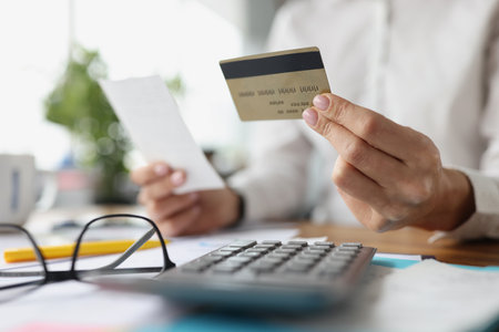 Credit plastic bank card and check in female handsの写真素材