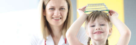 Little girl indulging in appointment with pediatrician in clinic