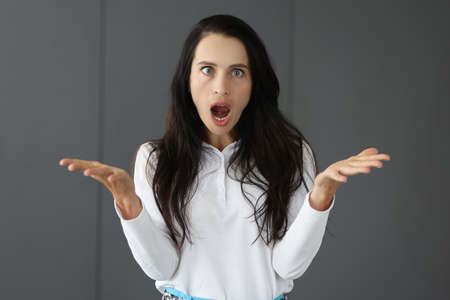 Portrait of young surprised woman with squintの写真素材