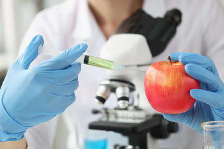Doctor scientist makes injection into apple in laboratory