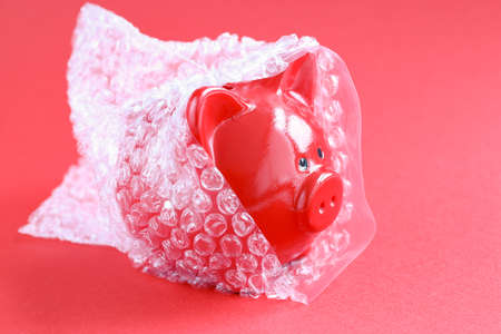 Pig piggy bank wrapped in gummy plastic bagの写真素材