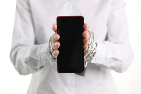 Female tied hands with chain hold mobile phoneの写真素材
