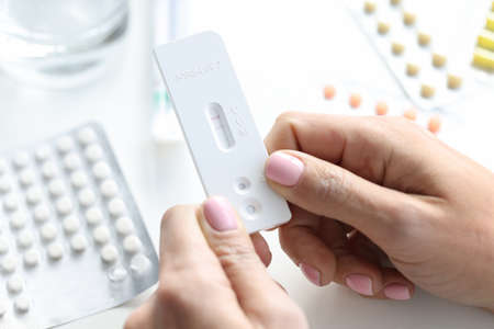 Female hands positive PCR test for virus infectionの写真素材