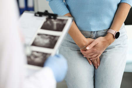 Woman with uterine problems and urination at gynecologist appointmentの写真素材