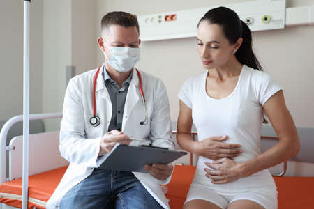 Doctor conducts medical examination of female patient in clinic