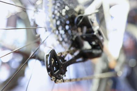 Closeup of iron chains on rear wheel of bicycle
