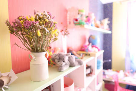 Dried flowers for decoration are in vase in children room closeupの写真素材