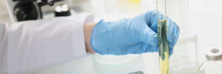 Scientist conducts laboratory tests of transparent liquid in test tube