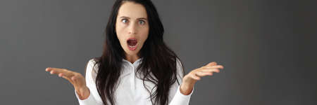 Portrait of young surprised woman with squintの写真素材