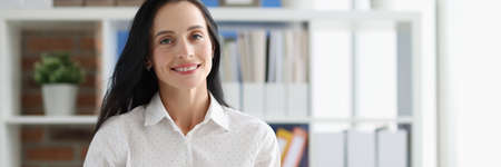 Smiling female business consultant at working table in officeの写真素材