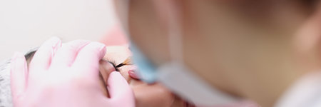 Master makes permanent makeup for eyelids of client in salonの写真素材