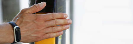 Male hand presses a button on a pedestrian crossing