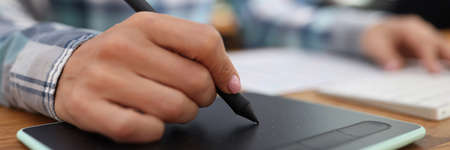 Graphic editor retouching drawings on graphic tablet in studioの写真素材