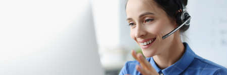 Woman with headphones and microphone communicating online