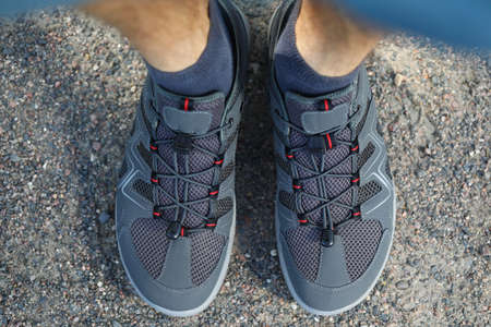 The man is wearing sneakers on his feet