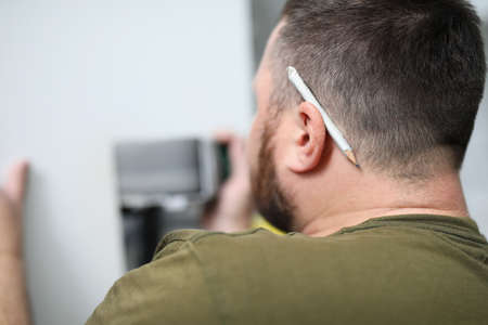 Male worker looking at the wall close up