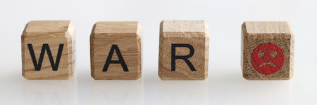 Word war on wooden cubes and sad emoticon closeupの写真素材