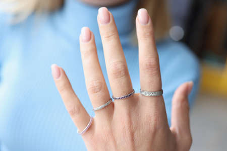 Woman hand with beautiful thin silver rings