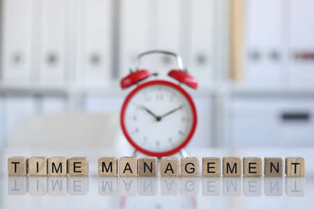 Time management and red alarm clock on table closeupの写真素材