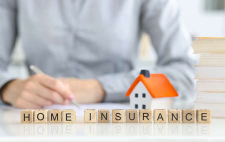 Agent fills out a home insurance form closeupの写真素材