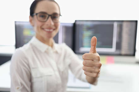 Online stock broker holding thumbs up closeupの写真素材