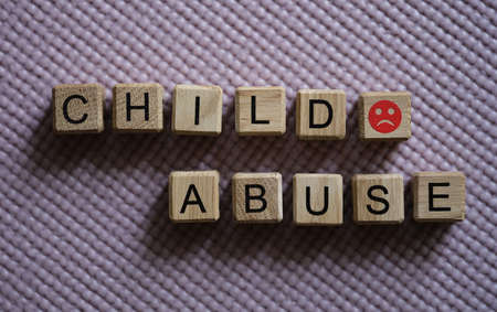 Text abuse child angry emoticon on cubes closeupの写真素材