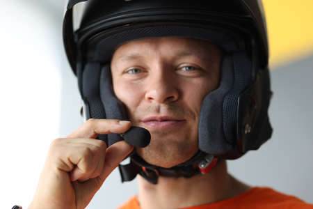 Male wearing helmet with microphone for hands free connection, interphone for motorcyclistsの写真素材