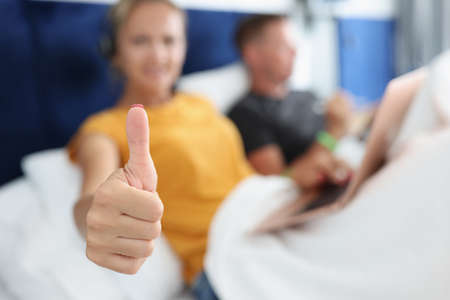 Freelancer holds thumbs up gesture and recommends working remotelyの写真素材