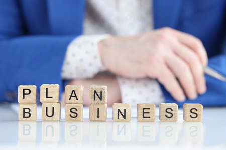 Business plan text on cubes and businessmanの写真素材