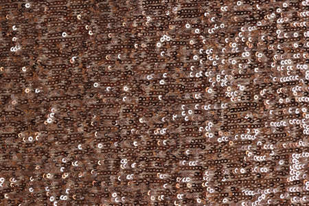 Shiny fabric with pink round inserts closeup