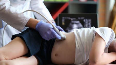 Medical examination of little girl using ultrasound equipmentの写真素材