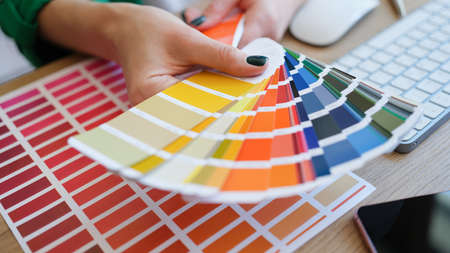 Graphic designer is working on choosing palette colors for creative business
