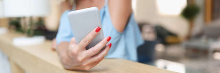 Woman uses smartphone and chats closeup. App concept
