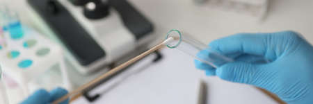 Doctor of laboratory diagnostics making DNA examination to determine paternity closeup
