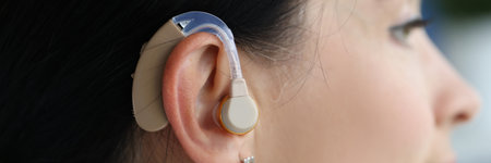 Hearing aid is on woman ear closeupの写真素材