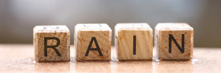 Inscription rain on wet wooden cubes closeupの写真素材