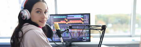 Disabled woman works as radio presenter in wheelchair in studioの写真素材