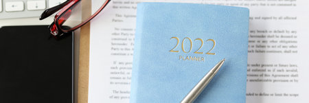 Lease agreement contract sheet, notebook planner for year, smartphone device, office deskの写真素材