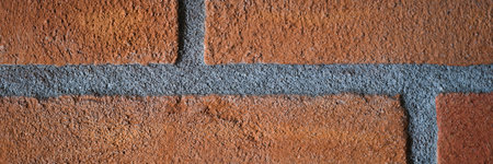 Wall painting of rough red brick with seams