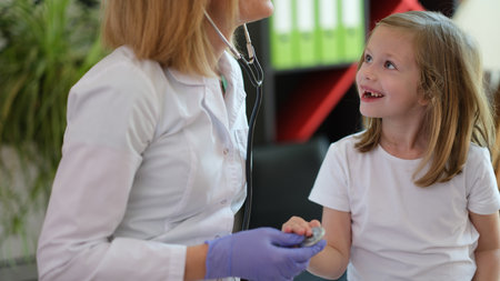 Female doctor examining little girl in office.の写真素材