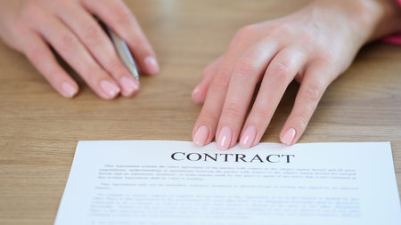HR manager asks new employee to sign contract.の写真素材