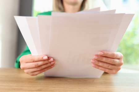 Manager reads documents while sitting at office desk.の写真素材