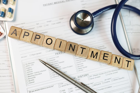 Word appointment collected from wooden cubes on medical documents with stethoscope and pills.の写真素材