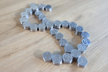 Dollar sign shaped stacks of coins on table