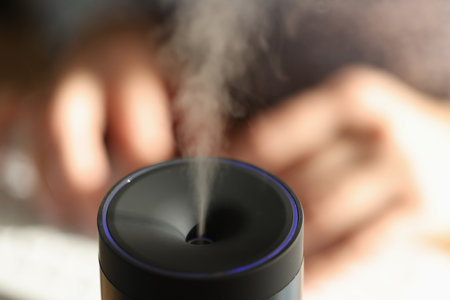 Black essential oil diffuser with steam flow.の写真素材