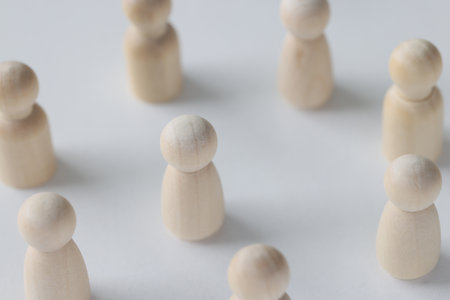 Female and male wooden figures are scattered on white background.の写真素材