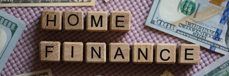 Home finance inscription on wooden cubes and cashの写真素材