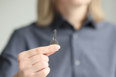 Woman shows key to just bought own apartment closeupの写真素材